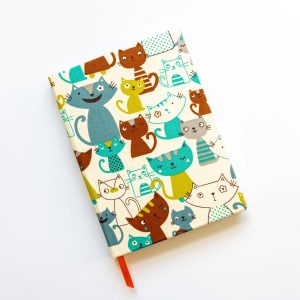 Handmade hardback journal is covered in soft cotton fabric featuring a simple cartoon kitty design